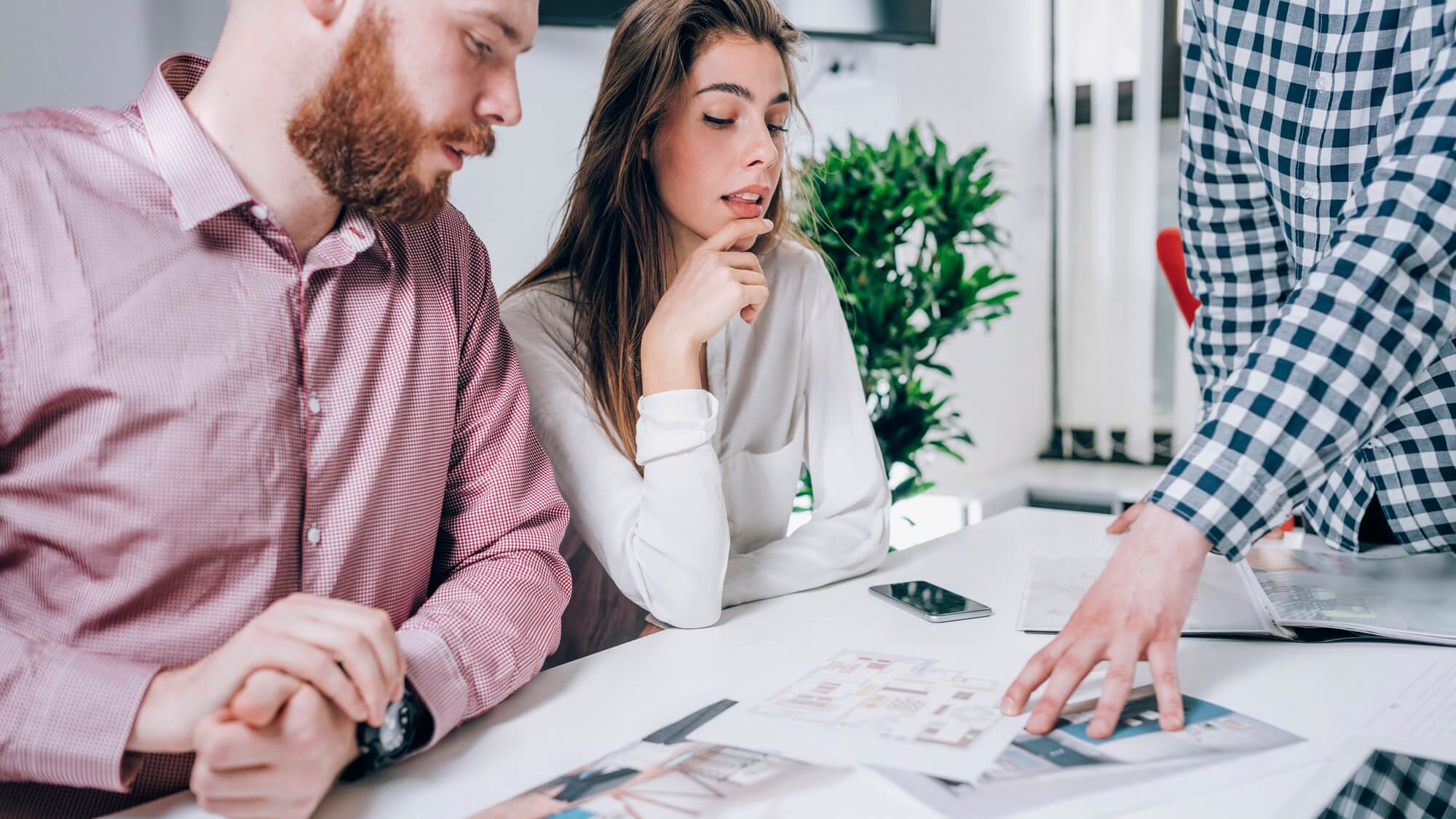 couple-in-real-estate-agency-talking-to-real-estate-agent-1.jpg
